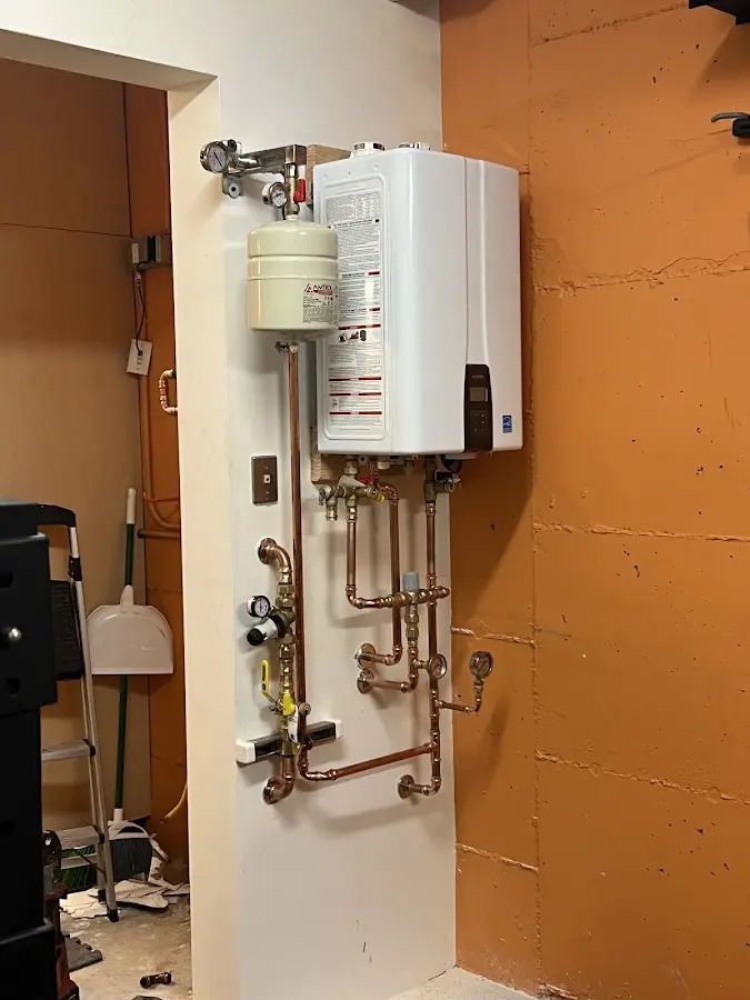 Plumbing technician inspecting water heater connections in Escondido